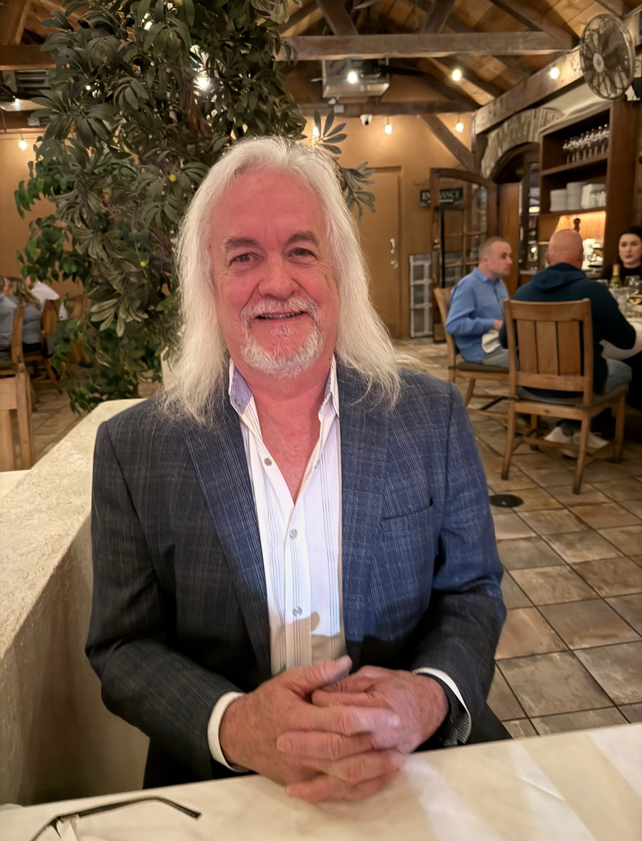 Lou Webber, LegalShield independent associate, smiling at a restaurant table